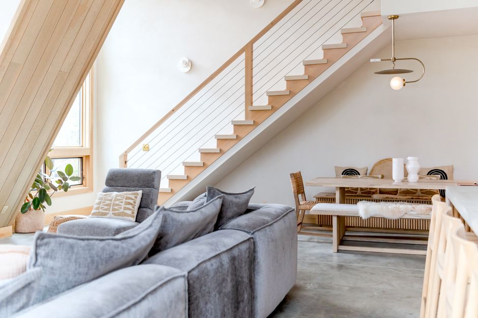 Warm styled living room in an Airbnb with sofa, plants and natural light